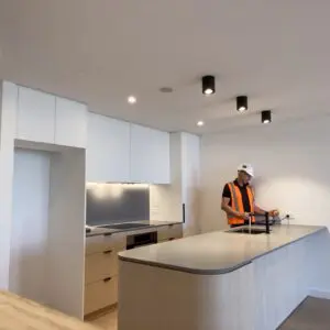 Building Inspector in an apartment kitchen reviewing finish