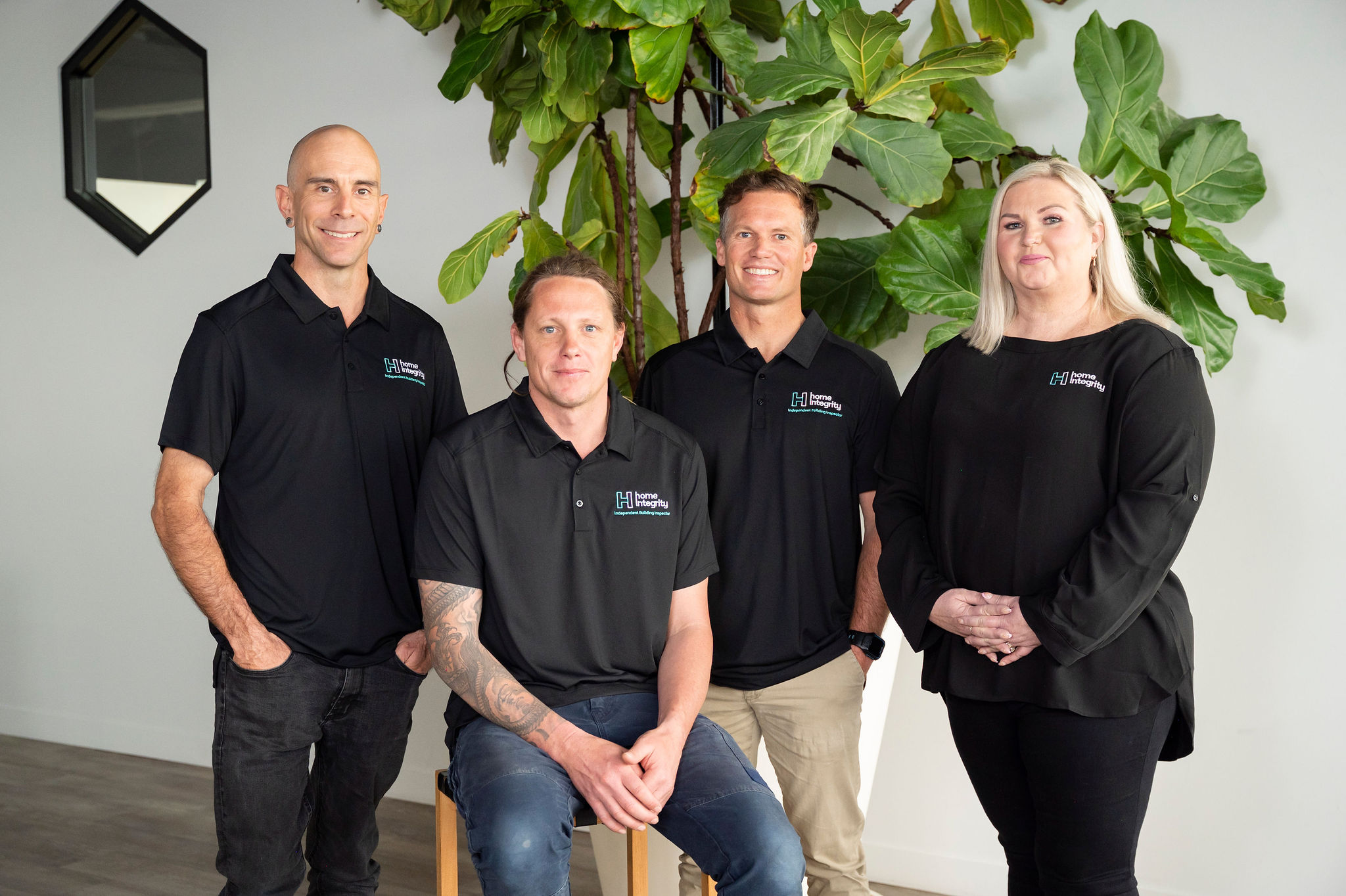 Smiling team of three men and one woman